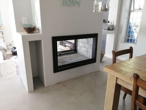 Double sided brick fireplace with frame and single doors