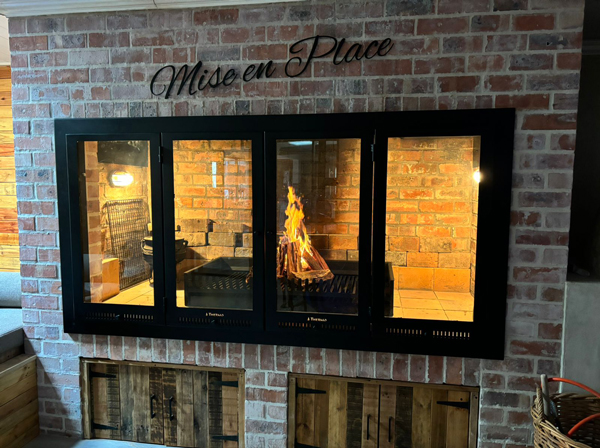 Custom Frame with Stacker Glass Doors added to customer's brick fireplace